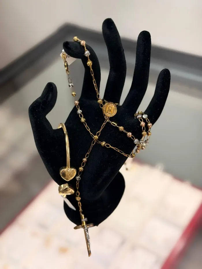 Gold rosary and bracelets on display