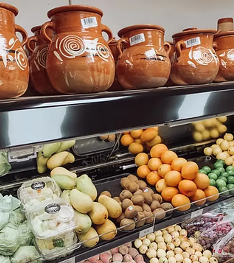 Fresh produce beside traditional clay pots